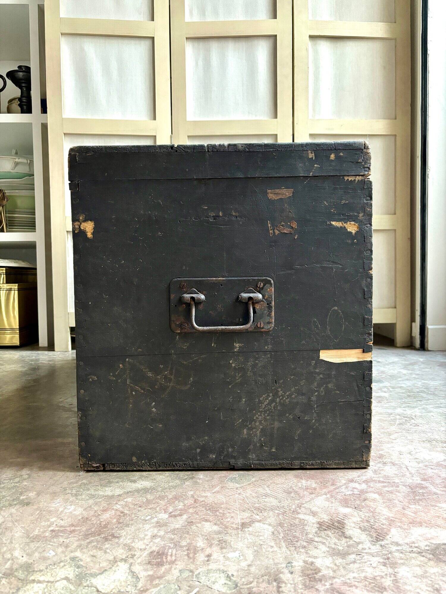 Trunk, black wooden chest and wallpaper