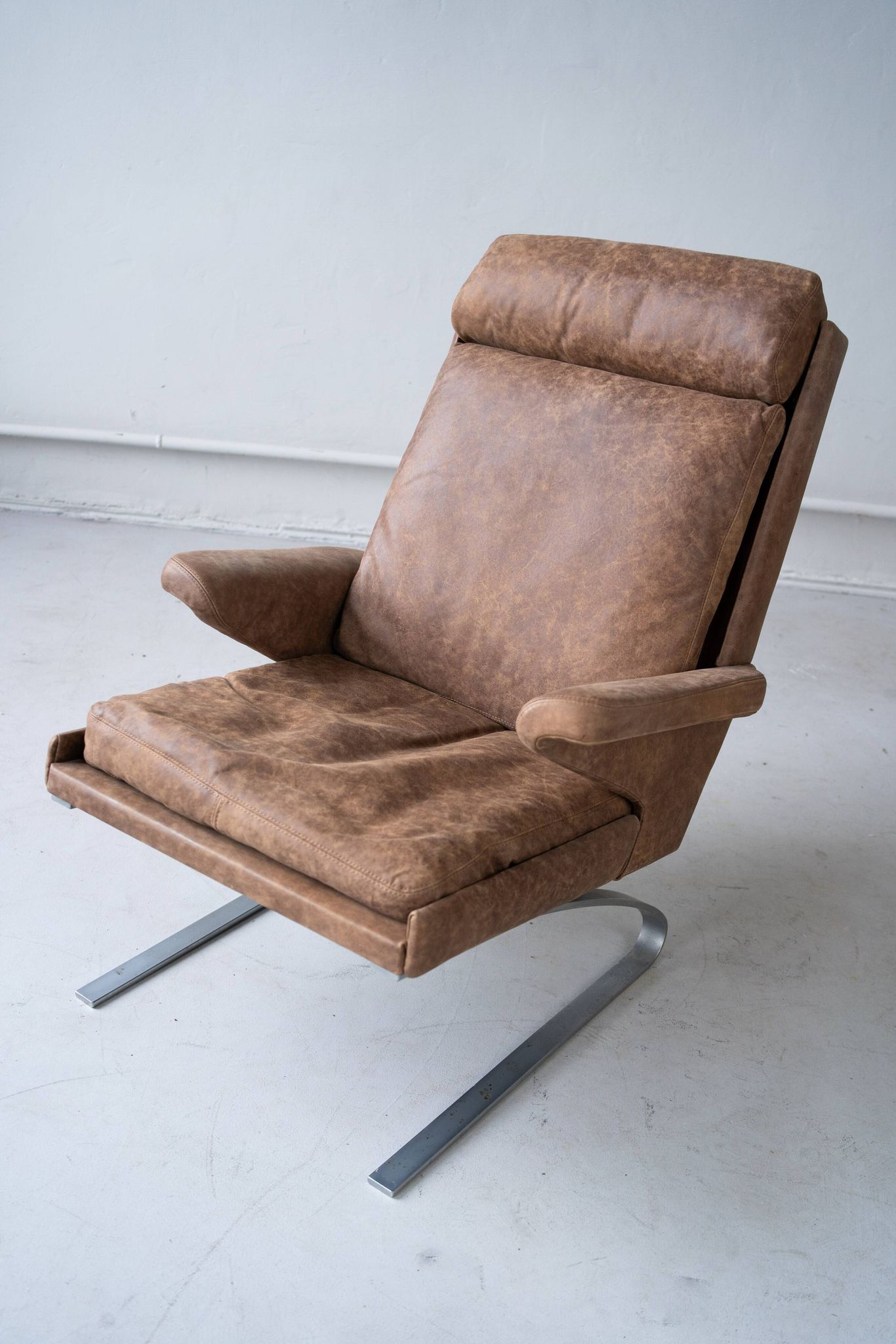 Vintage swing armchair and stool in leather by reinhold adolf for cor, 1970s, set of 2