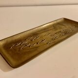 Bronze pocket emptier with fish decoration.