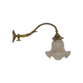 Brass wall sconce with a glass tulip