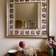 Large square ceramic mirror with floral decoration.