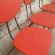 Lot of 6 red chairs in faux leather metal compass feet