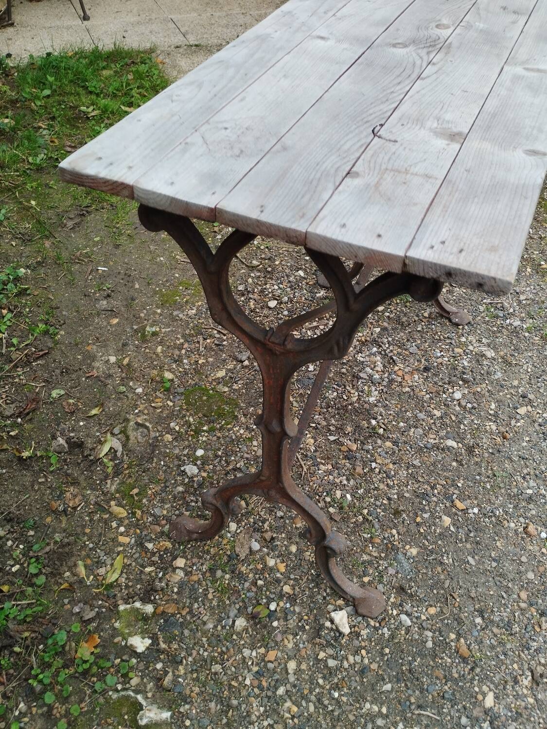 Antique bistro table with iron legs and wooden top