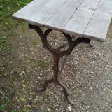 Antique bistro table with iron legs and wooden top