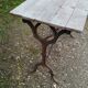 Antique bistro table with iron legs and wooden top
