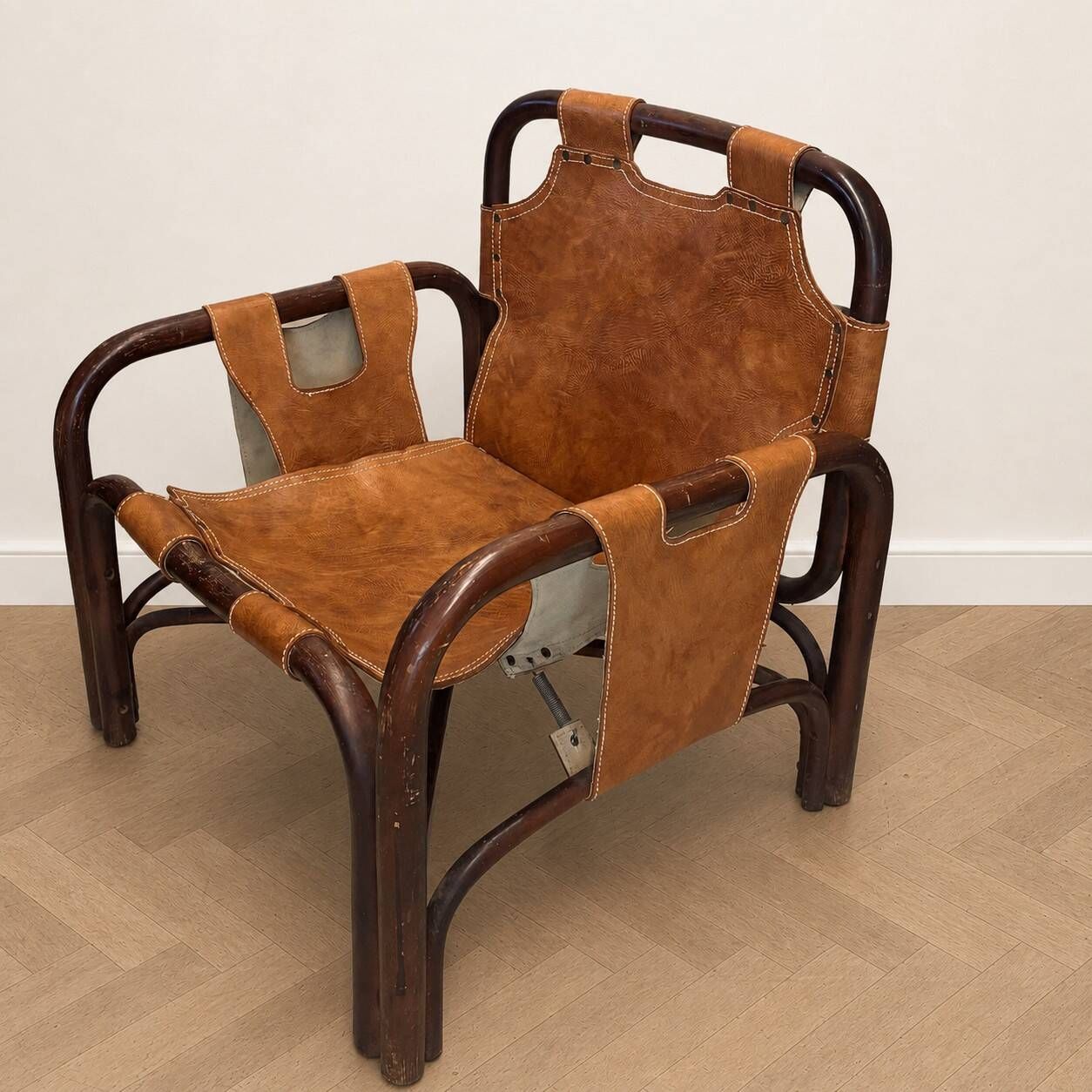 Pair of Tito Agnoli armchairs in leather and bamboo, 1970s.