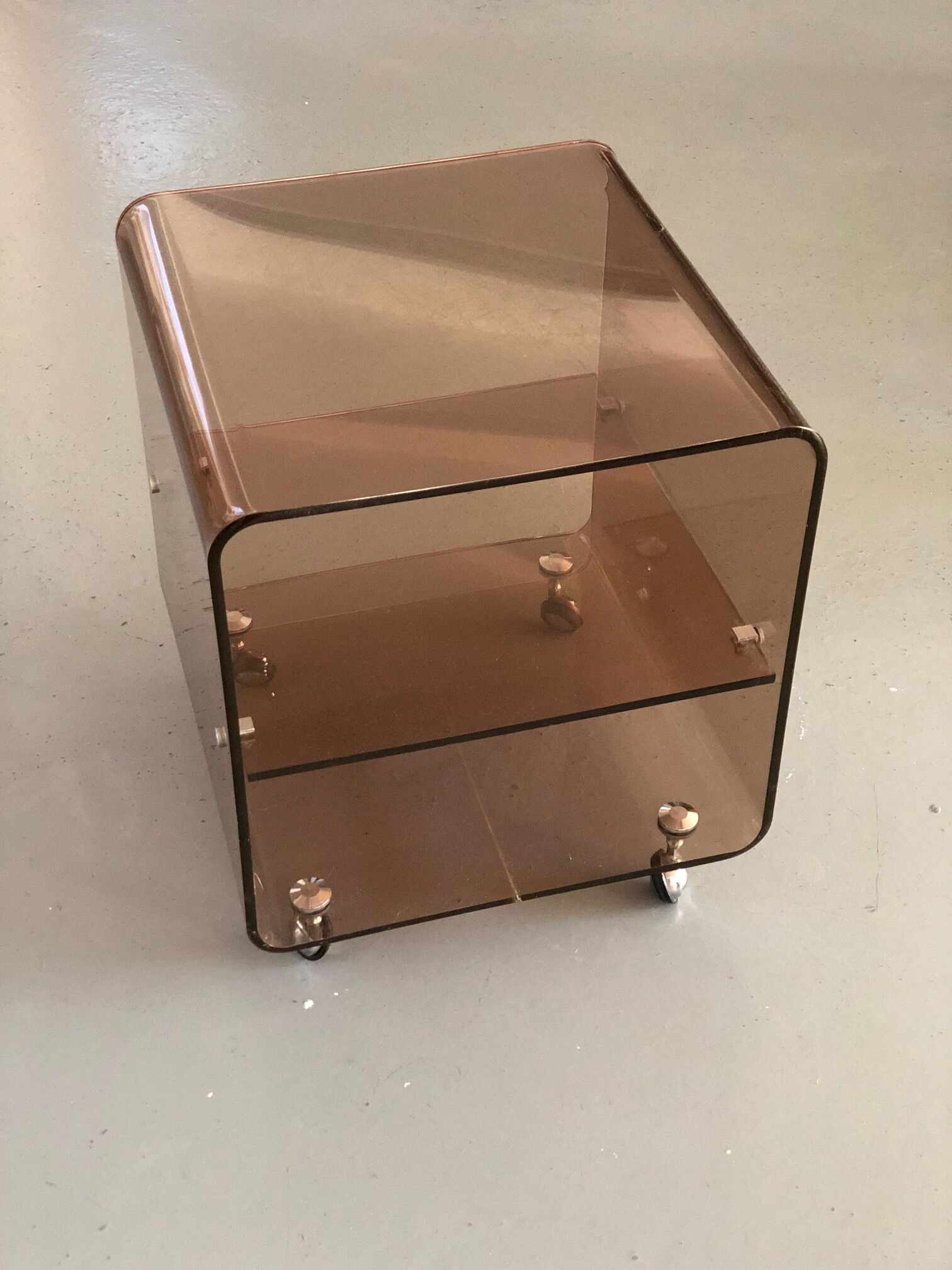 Served on wheels in smoked brown plexiglass 70s.