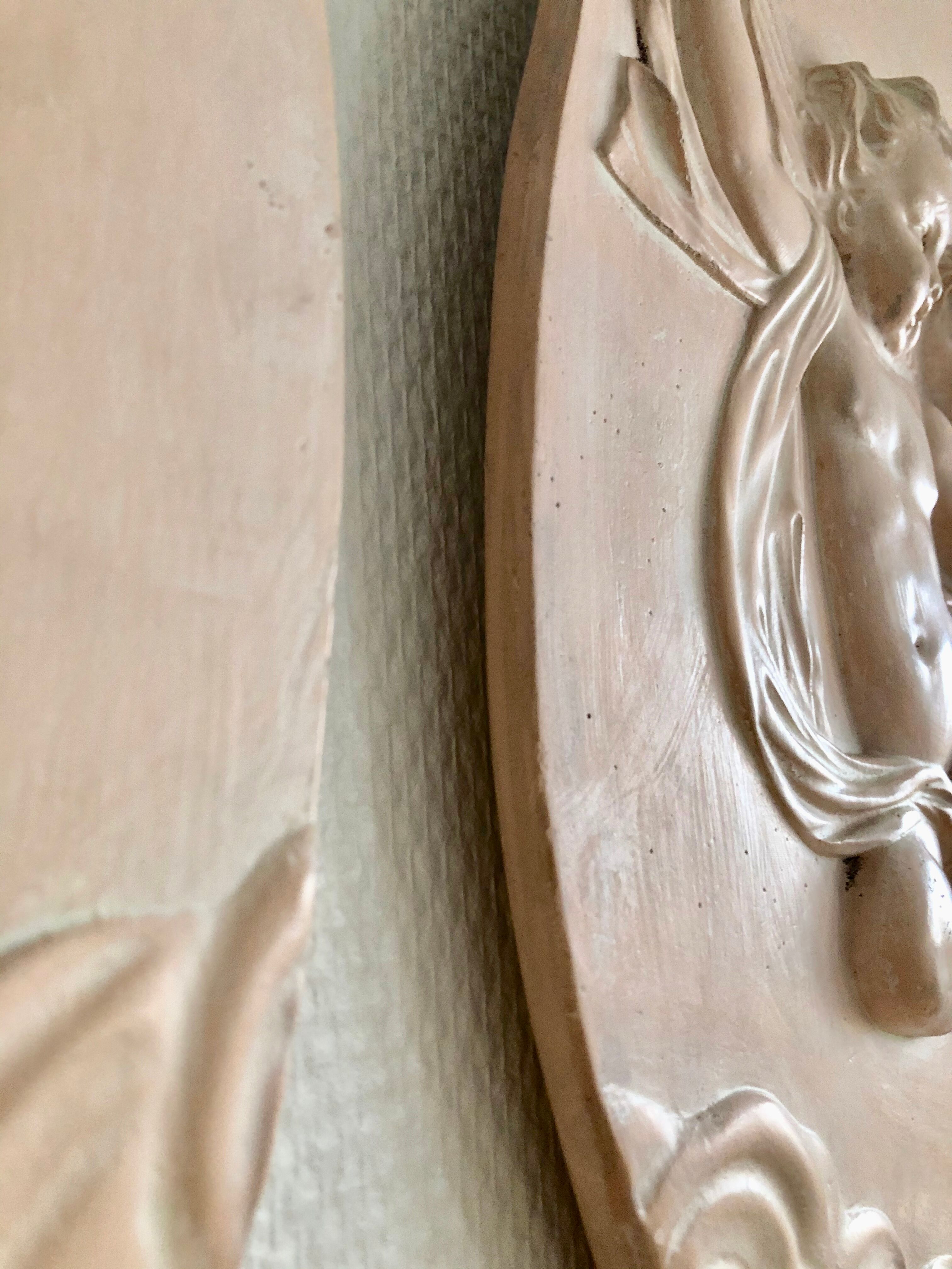 Pair of putti medallions