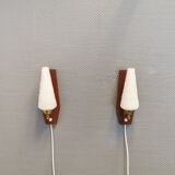 Danish wall lights from the 1970s, made of milky white glass shades, teak wood suspension and brass.