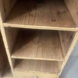 On a piece of furniture with sorting lockers and drawers