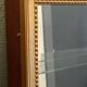 Vitrine en bois doré à suspendre .