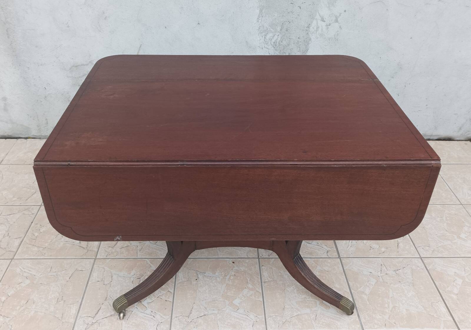 19th-century English style mahogany drop-leaf table.