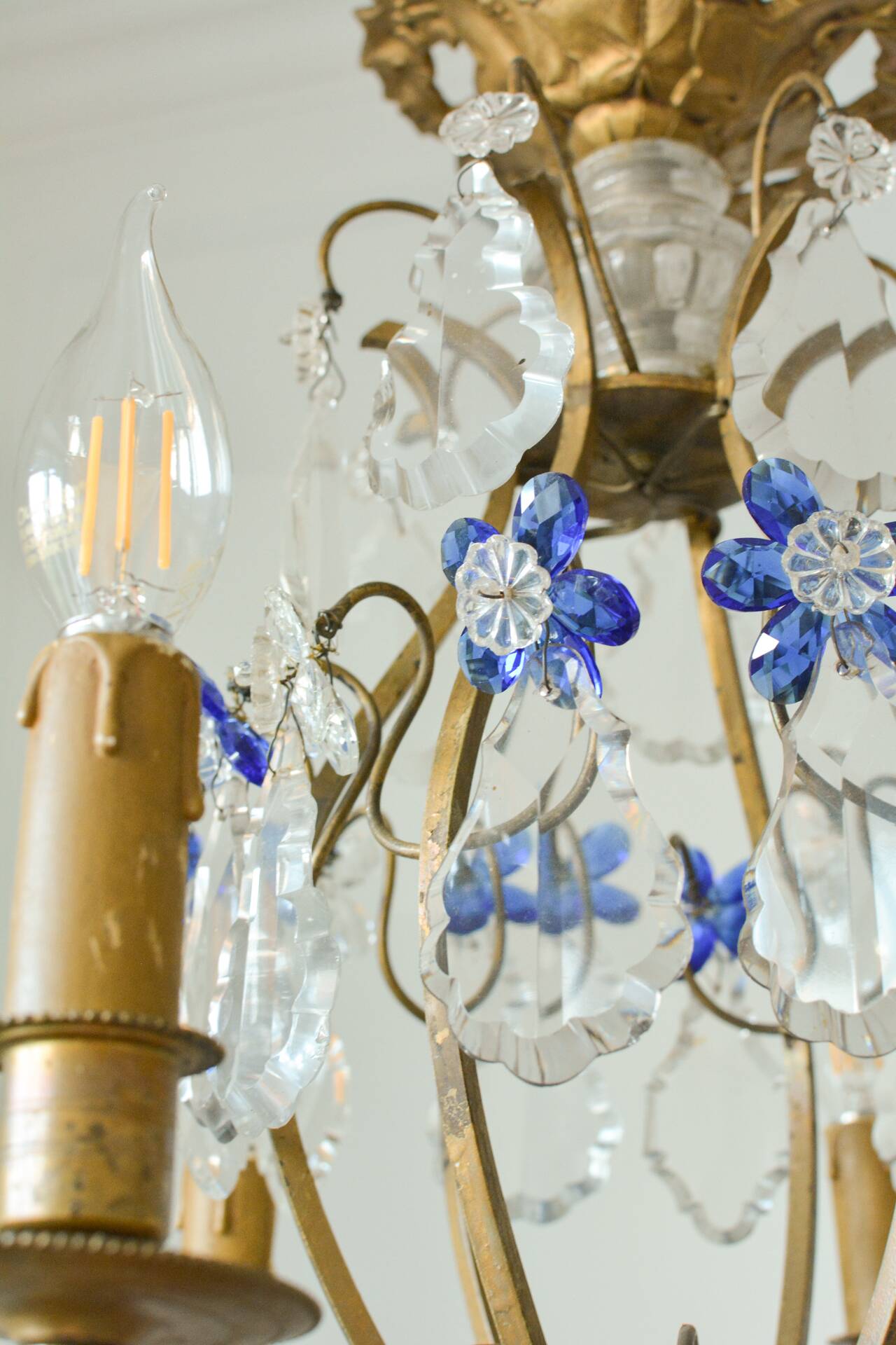 Antique French chandelier cage in gilded bronze and crystal, with blue pendants.