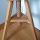 Tripod stool with a screw.