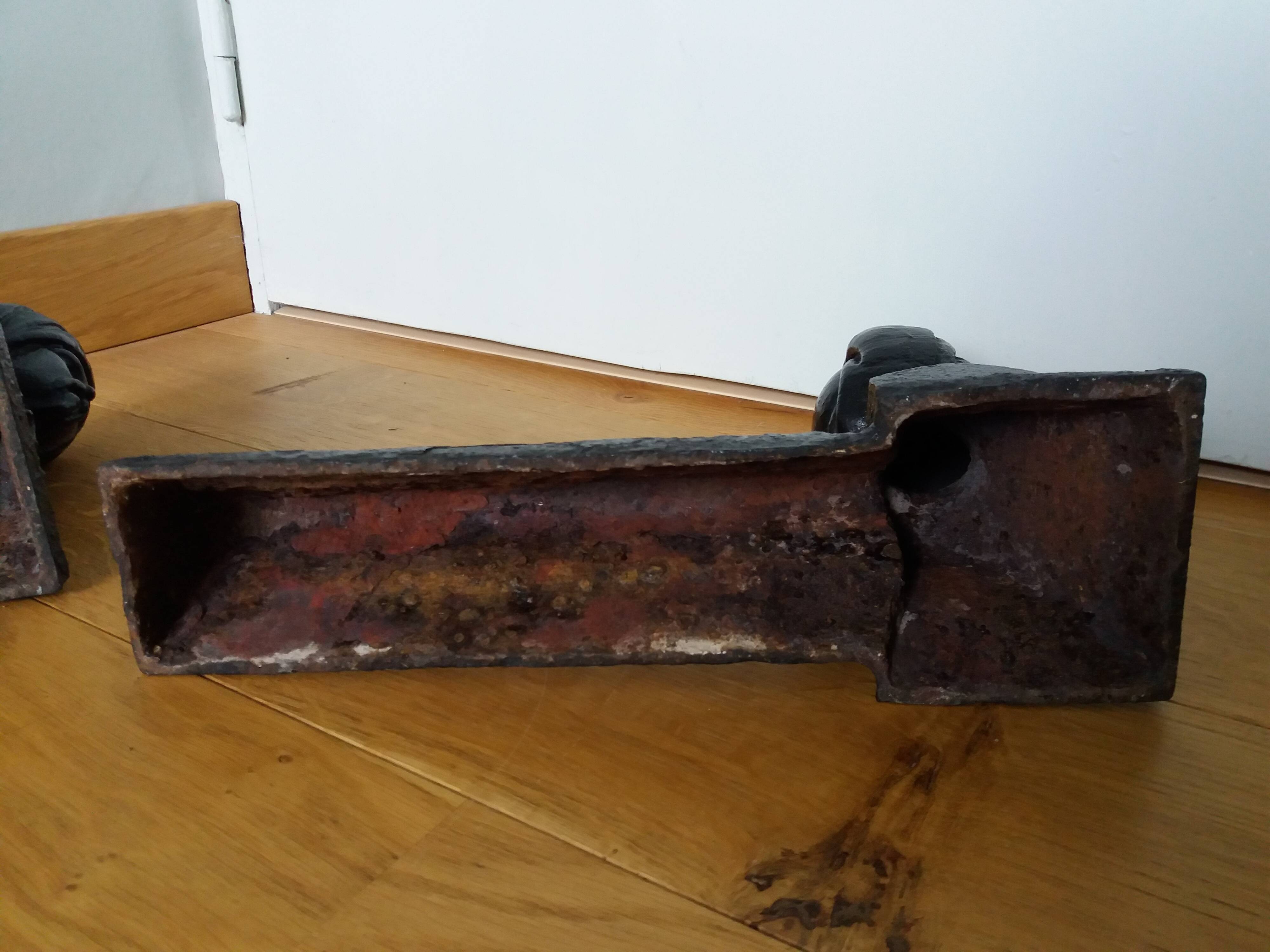 Cast iron andirons with character heads