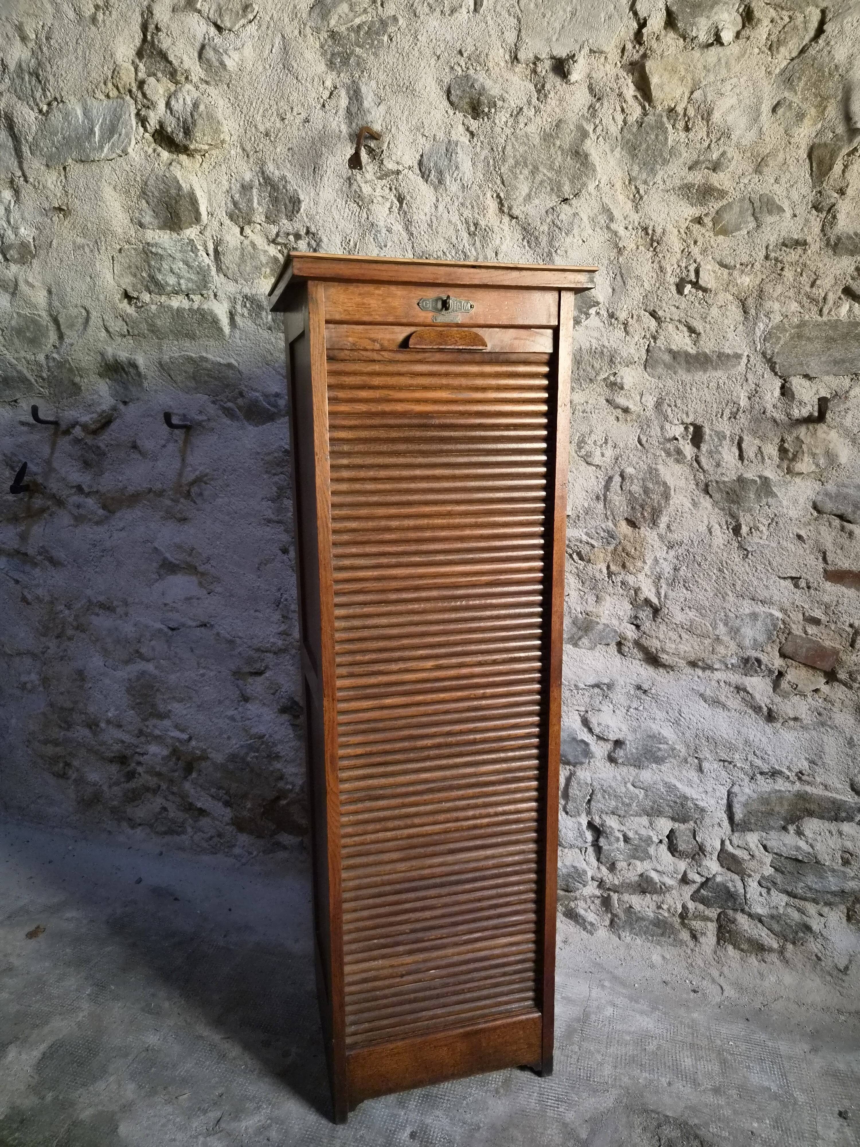 French antique wardrobe with curtain in oak, circa 1920–1930.