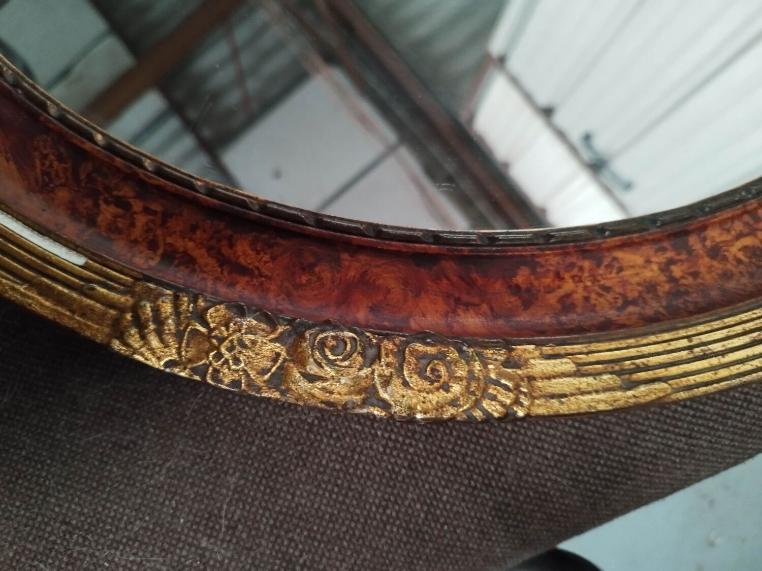 Golden oval art deco mirror