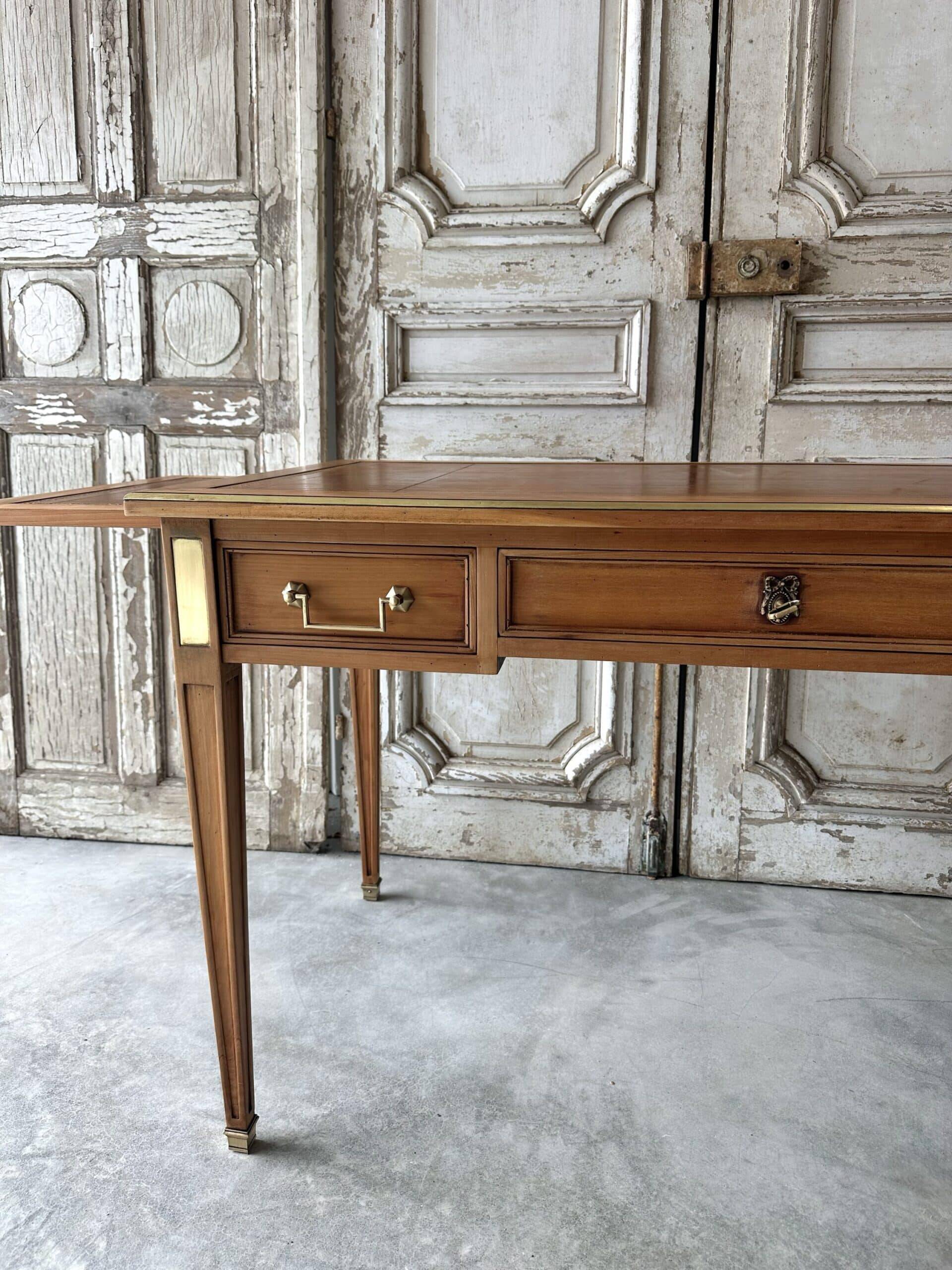 Directoire style flat desk circa 1960 in light cherry wood.