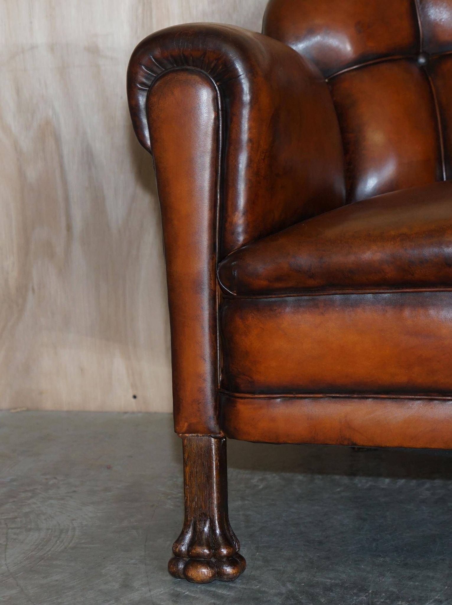 Victorian Chesterfield leather canapé with oak lion claw feet.
