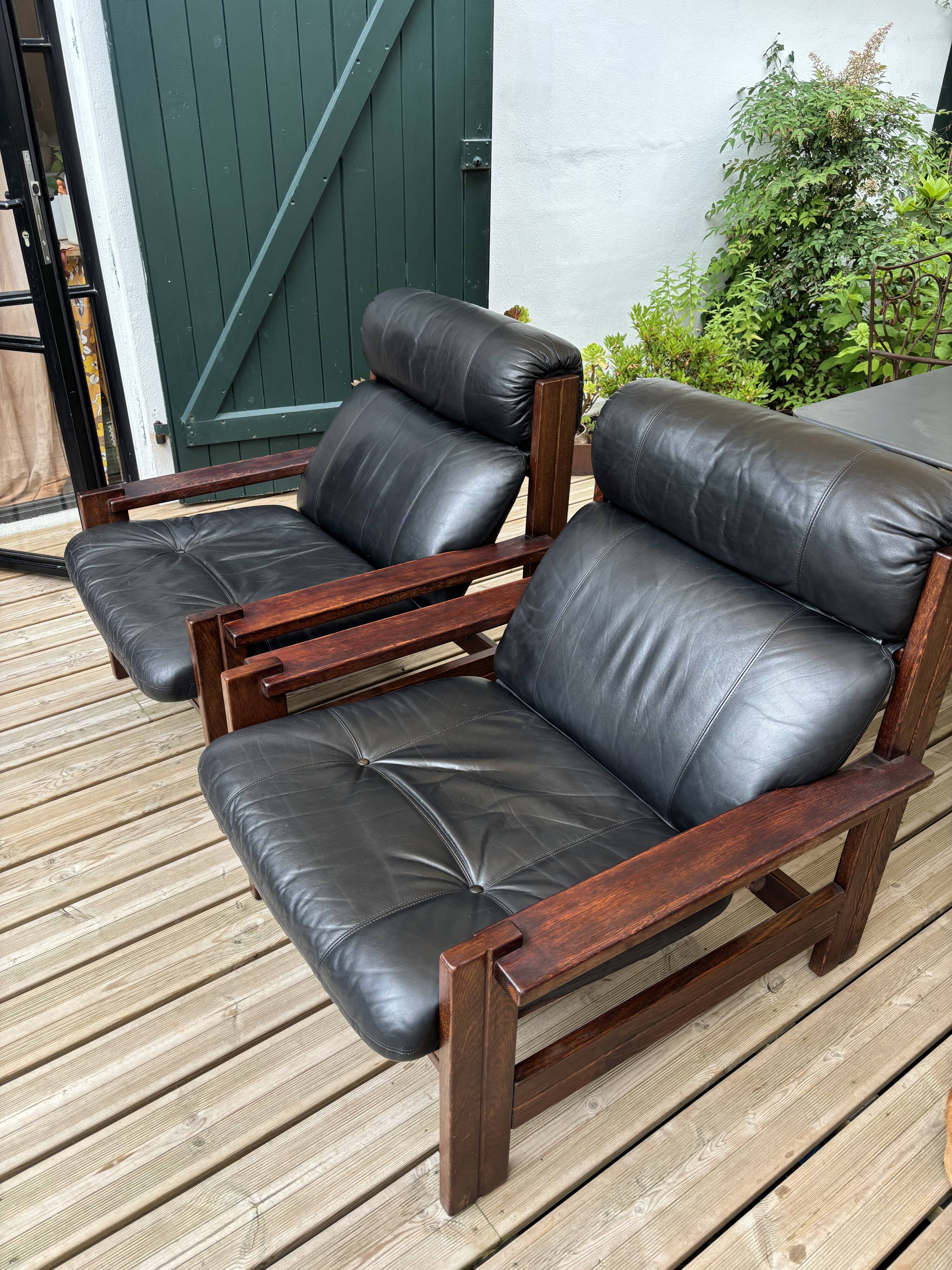 Vintage Scandinavian armchairs in leather and solid wood.