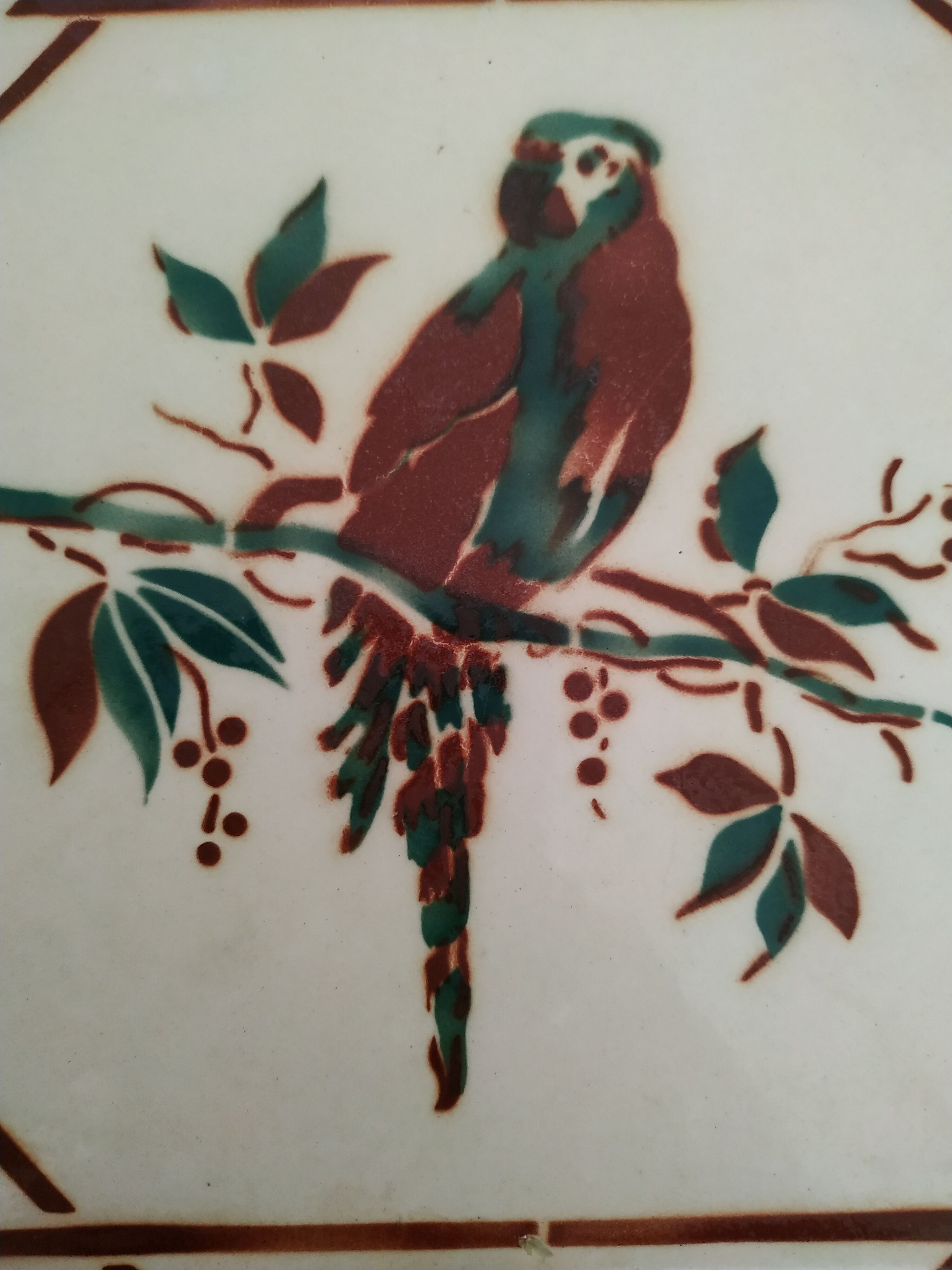 Ceramic dish mat with parrot decoration