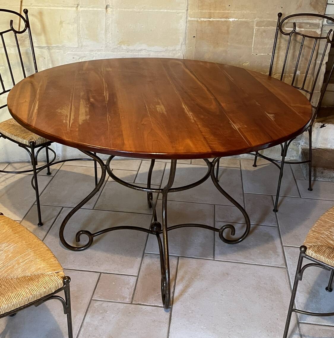 Table and four wrought iron and wood chairs.