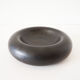 Empty round pocket in black ceramic