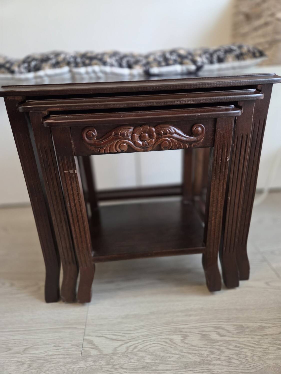 Nested tables made of varnished solid wood.