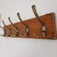 Wall-mounted coat rack with 5 vintage-style hooks in patinated wood and metal.