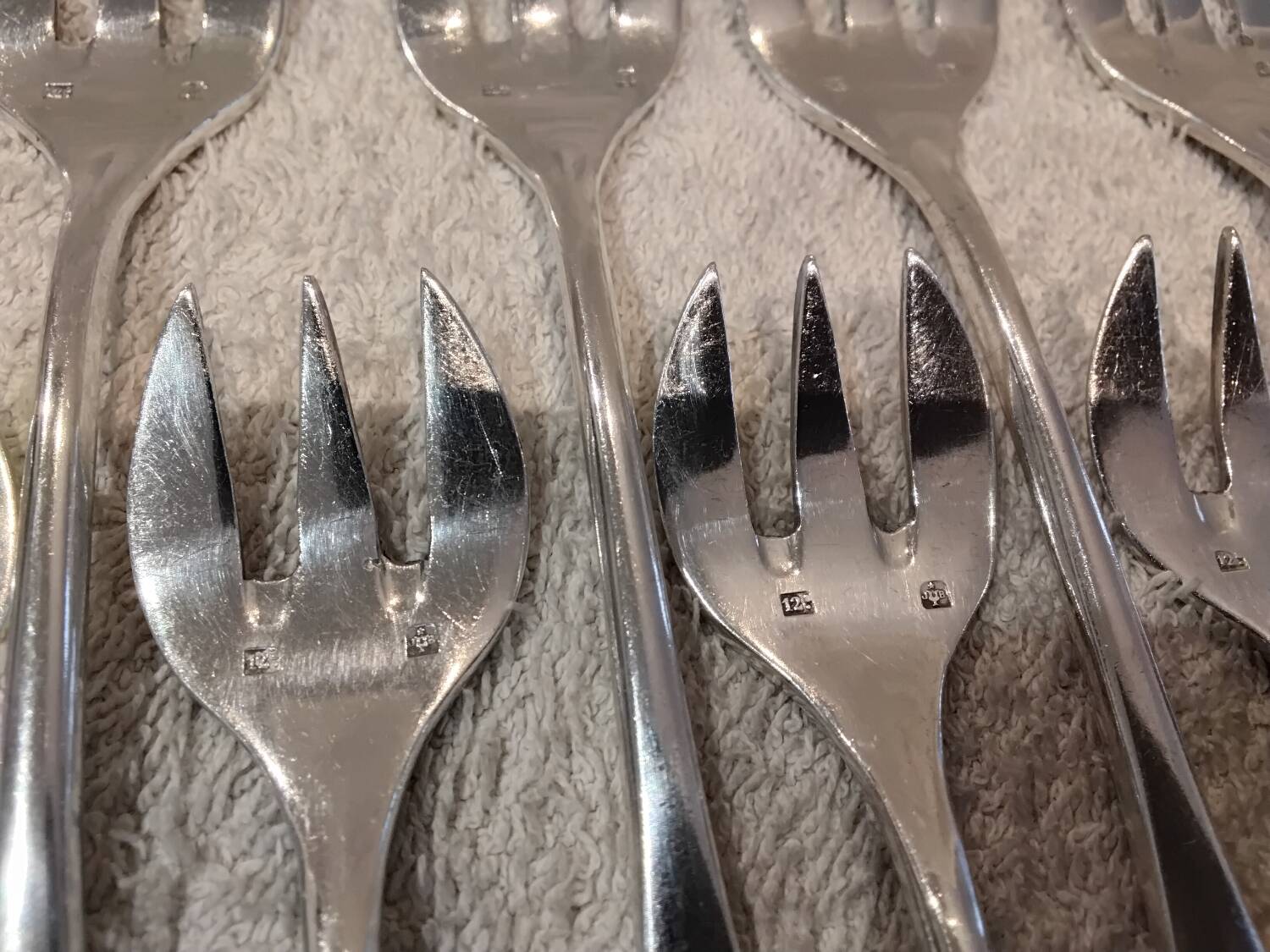 12 silver-plated oyster forks by silversmith J Brille with stick handles.