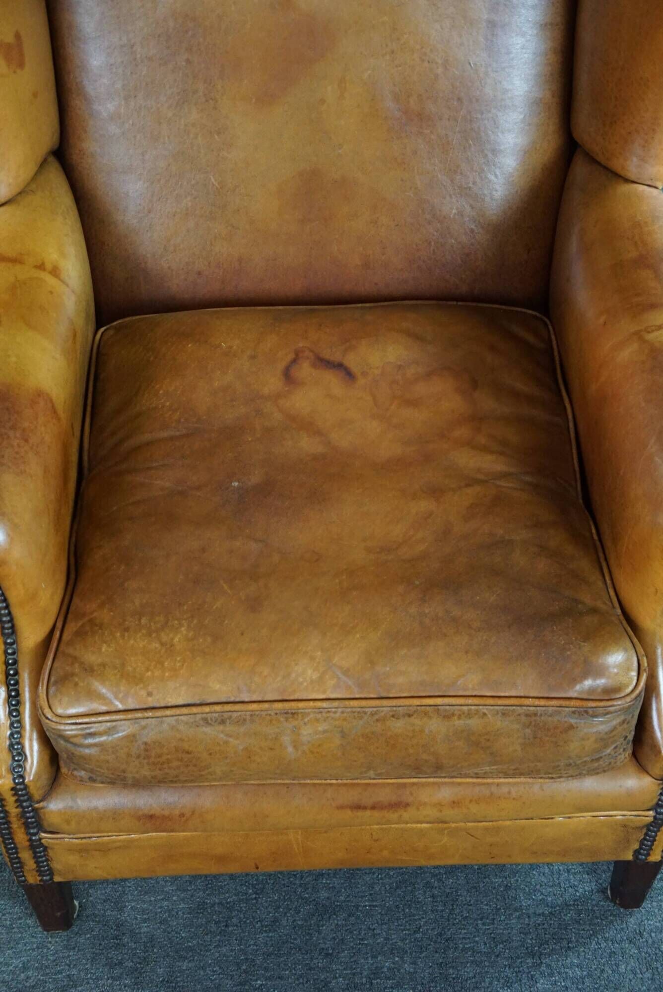 Wingback chair made of sheepskin leather in a light honey color