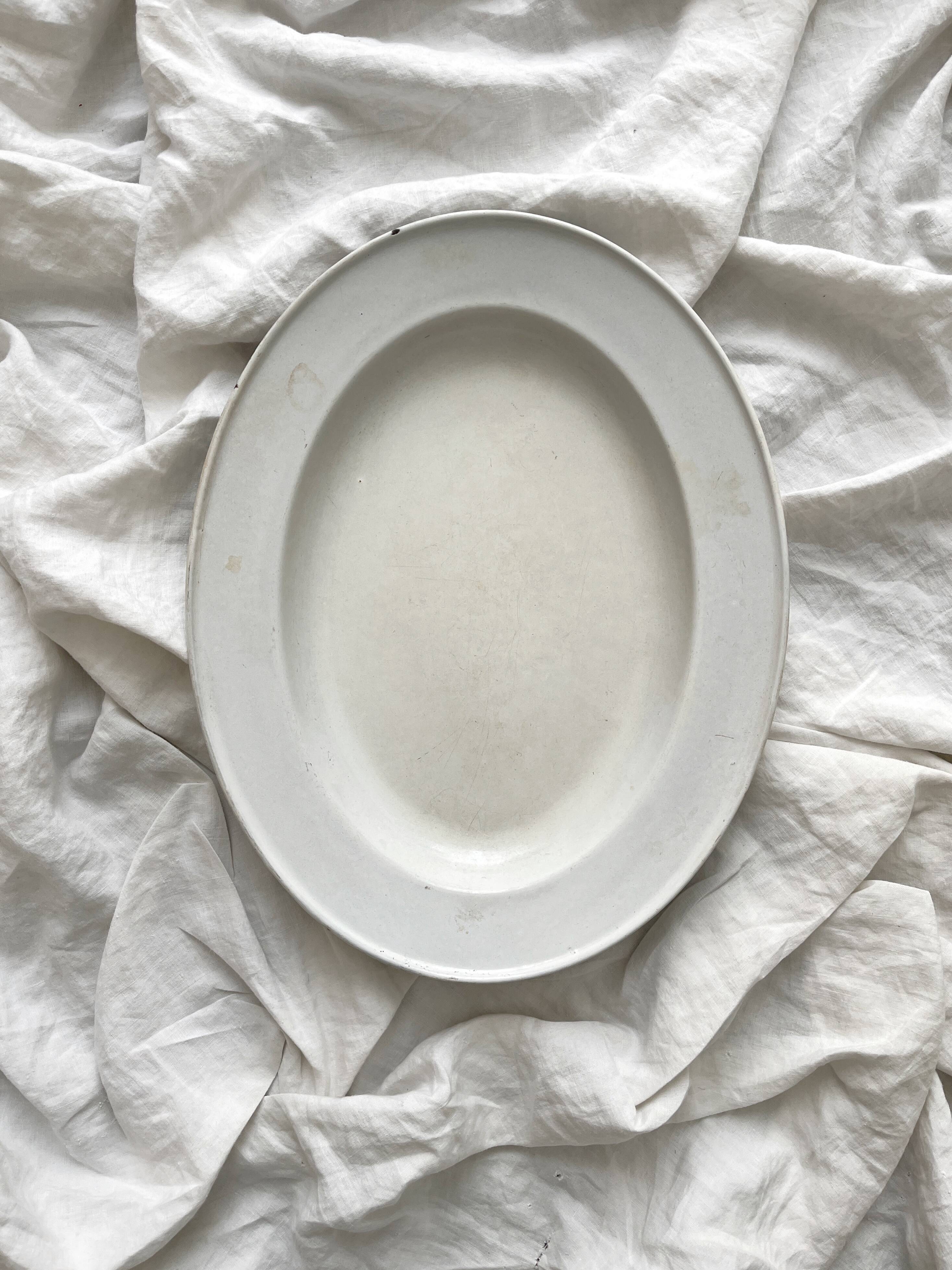 Vintage marbled white and blue enameled sheet metal oval dish