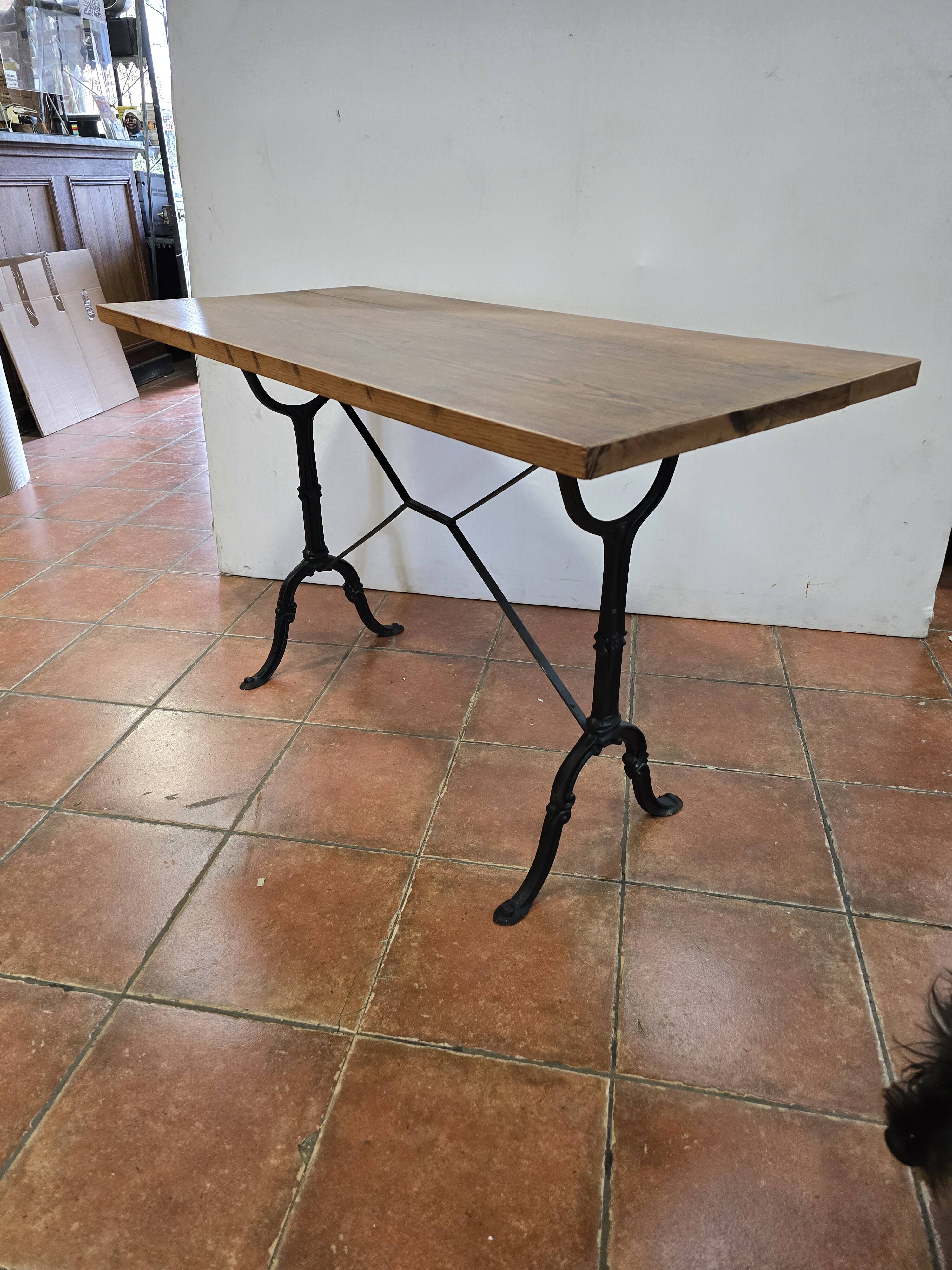 Old bistro table with oak top, cast iron base, 118 cm L
