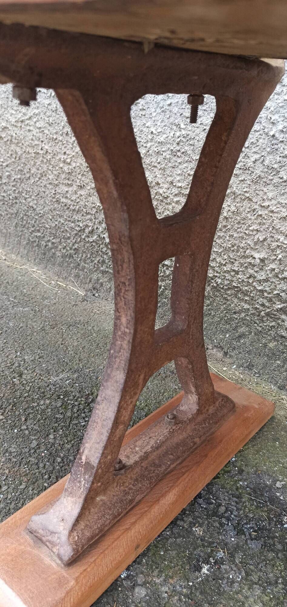 Old wooden bench with cast iron base