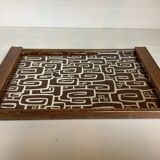 Old wooden tray with psychedelic art deco patterns