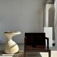 Small low armchair in varnished brown wood