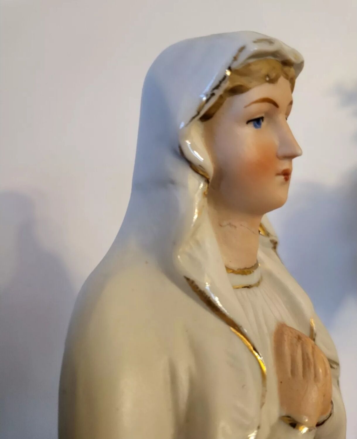 Religious statuette of the Virgin Mary in bisque porcelain