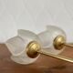 Pair of tulip-shaped candle holders in frosted glass and brass.