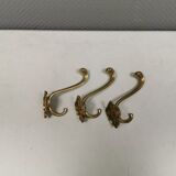 Three old and beautiful brass hooks with decorative motifs