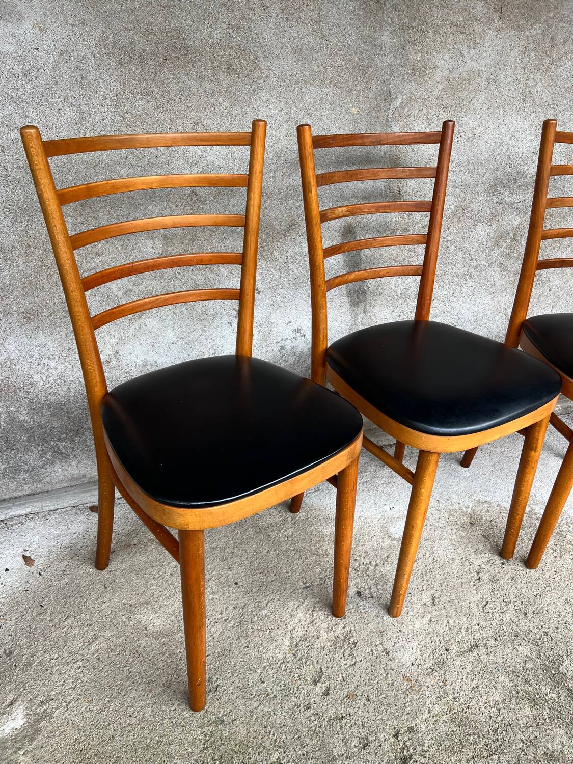 Set of 4 vintage wooden chairs with faux leather.