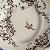 4 assiettes plates en terre de fer marron à décor d'oiseaux