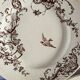 4 assiettes plates en terre de fer marron à décor d'oiseaux