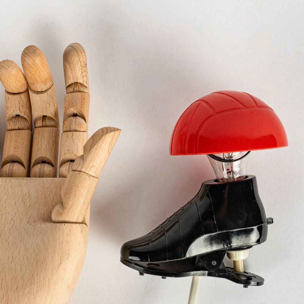 A small, wooden table lamp that stands on a tripod