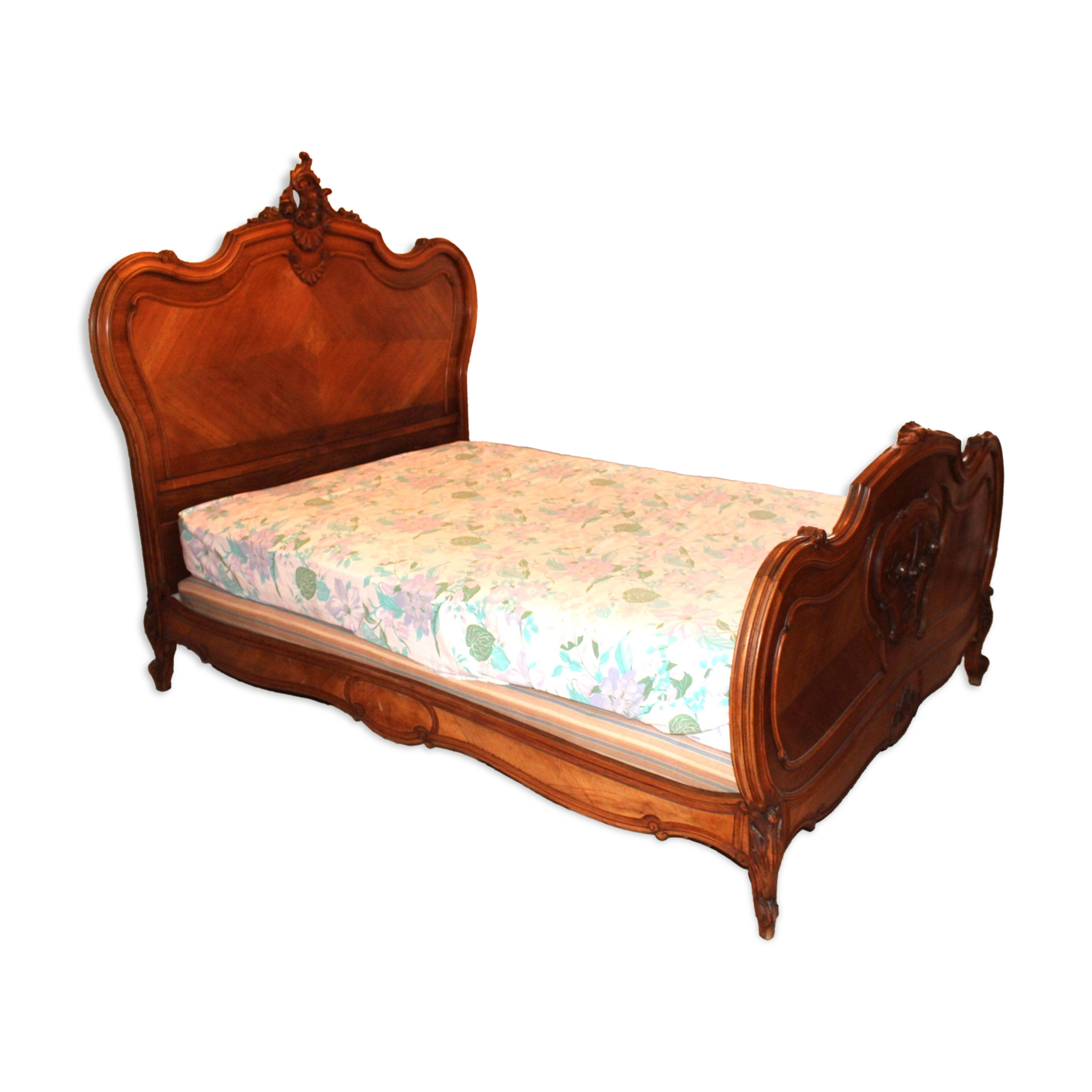 Walnut rocaille bed from the early 20th century.