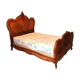 Walnut rocaille bed from the early 20th century.