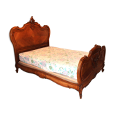 Walnut rocaille bed from the early 20th century.