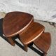 Nested tripod tables made of solid wood, in a modernist brutalist style.