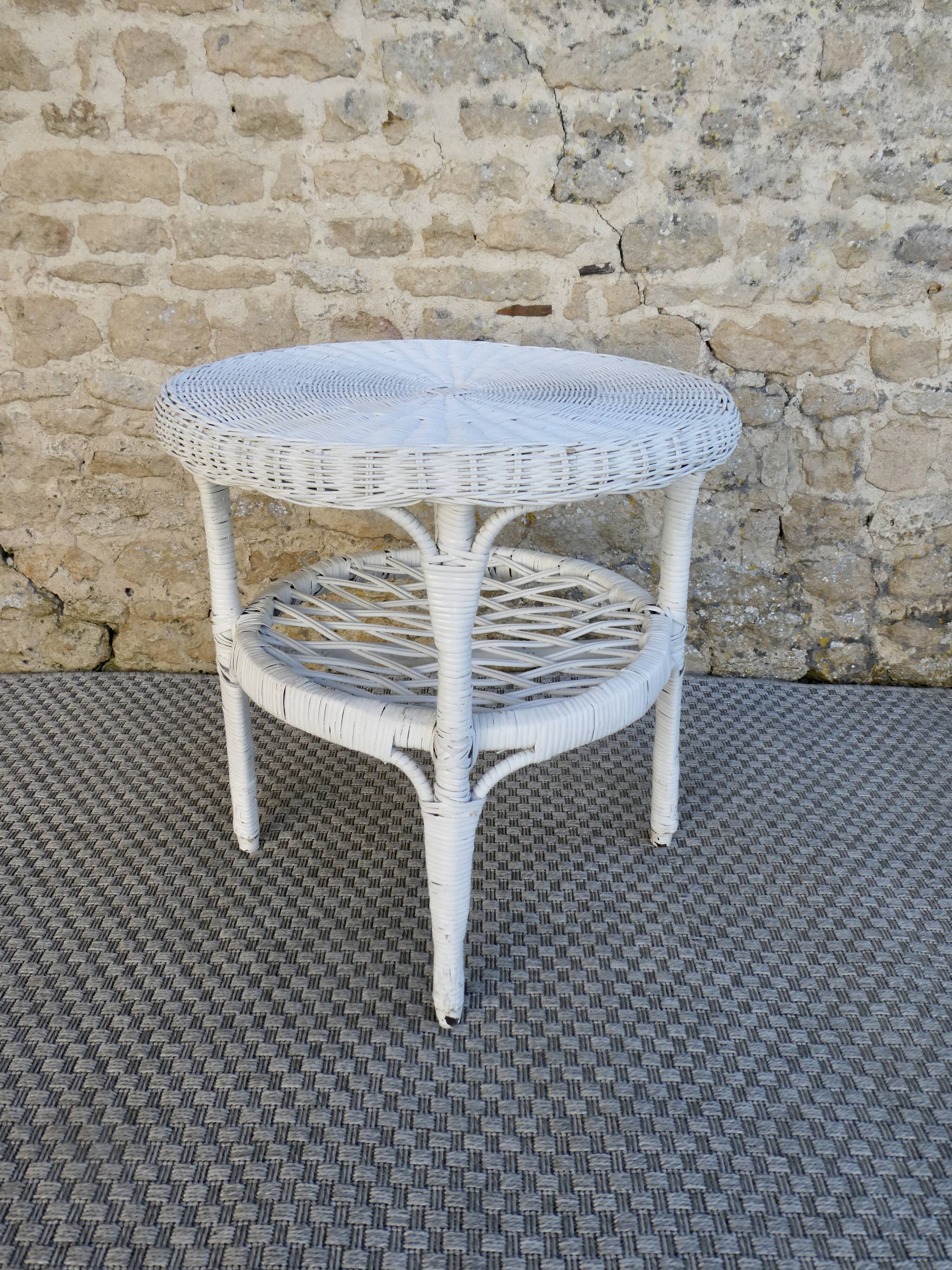 Round white rattan side table with storage underneath, circa 1970.