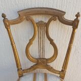 Pair of chairs with a golden lyre