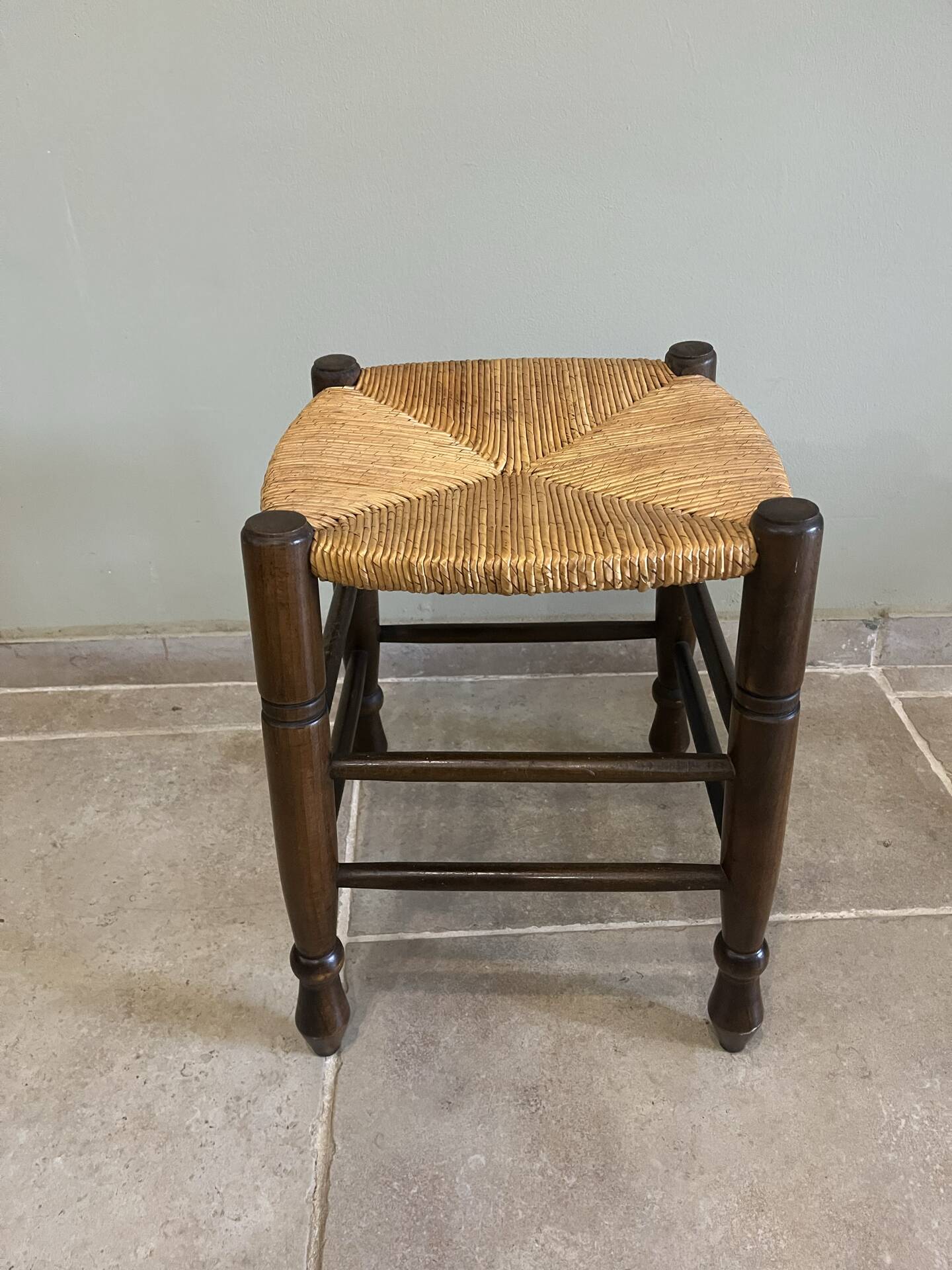 Wooden stool with a straw seat